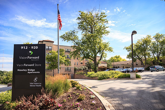 Vision Forward sign and building entrance on a beautiful, sunny day - image