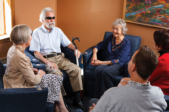 Five people ina circle having a conversation image