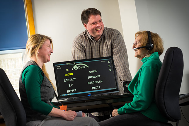 Vision Forward assistive technology specialists with an older woman at a computer image.