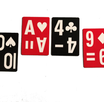 four cards are set in a row. From left to right are the ten of spades, ace of hearts, 4 of clubs and nine of diamonds. They are large print and high contrast. Clubs and spades are black. Hearts and diamonds are red.