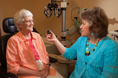 Dr. Heather Hinson performs a low vision exam on a client.