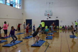 Camper participating in POUND activity.