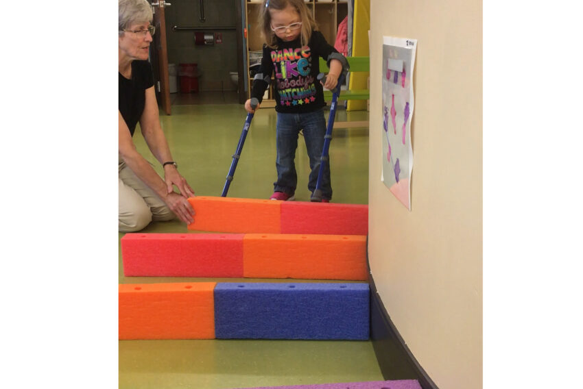 Girl with physical therapist.