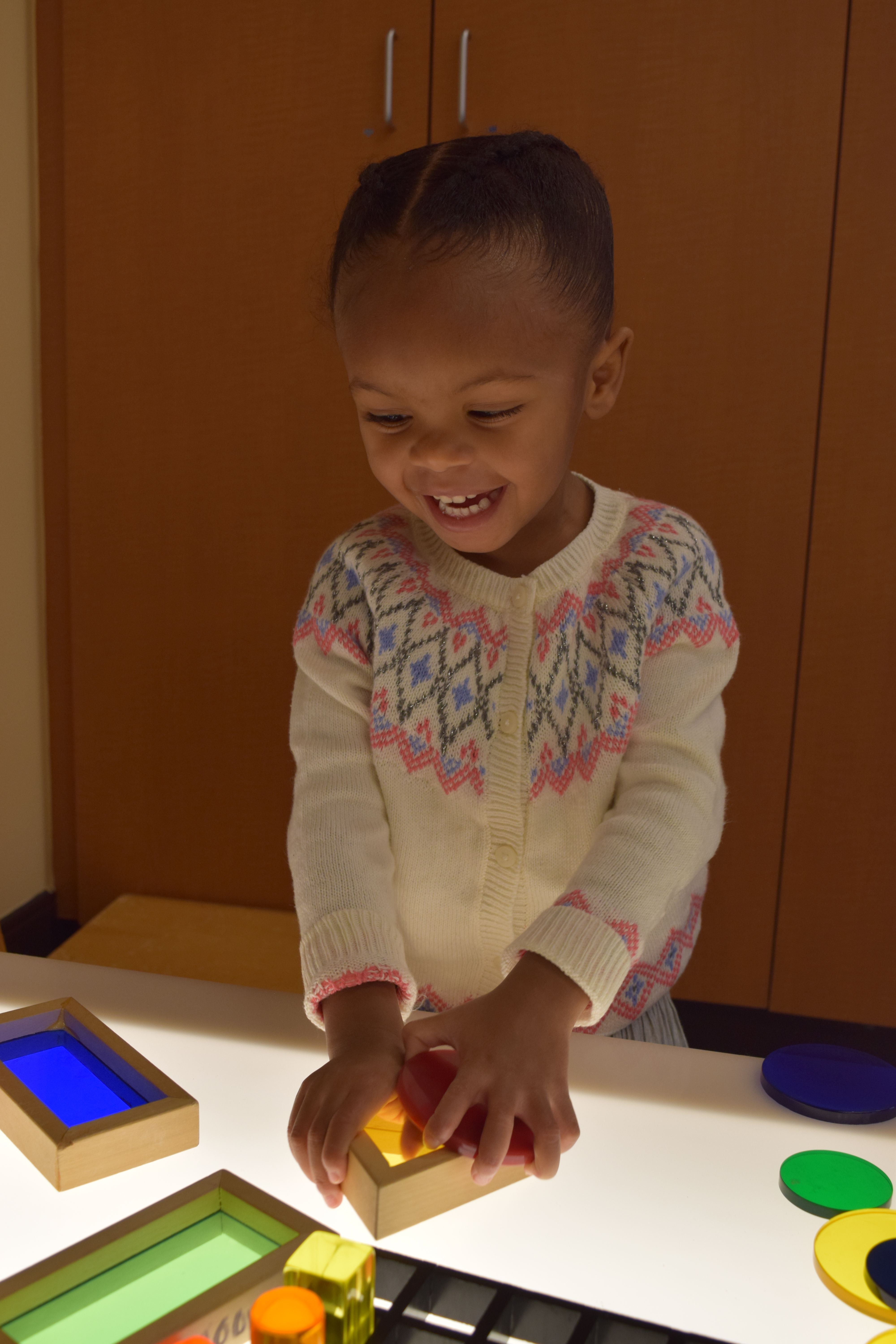 Young girl working at a light table.