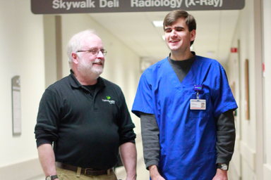 Steve McAuliff and Chuck Aprahamian training in the hallways of Froedtert Hospital.