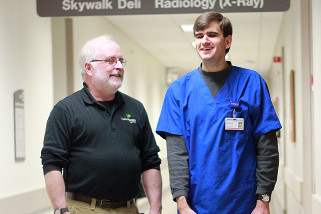 Steve McAuliff and Chuck Aprahamian training in the hallways of Froedtert Hospital.