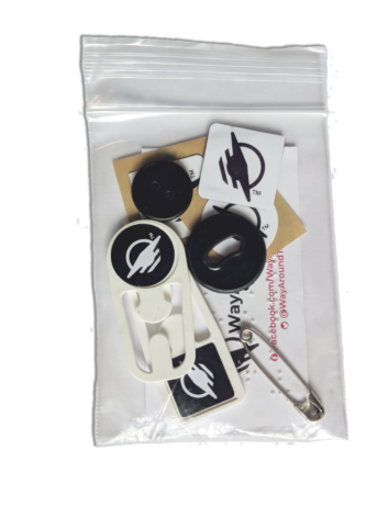 Clear baggie with a number of WayTags, buttons, magnets and a safety pin.