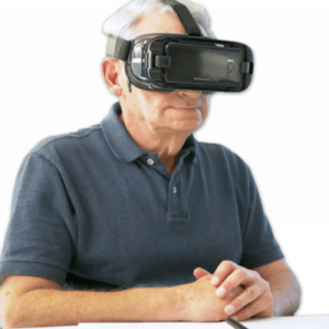 A man is sitting down at a table. He wears IrisVision.