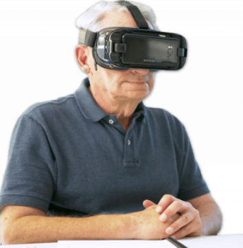 A man is sitting down at a table. He wears IrisVision.