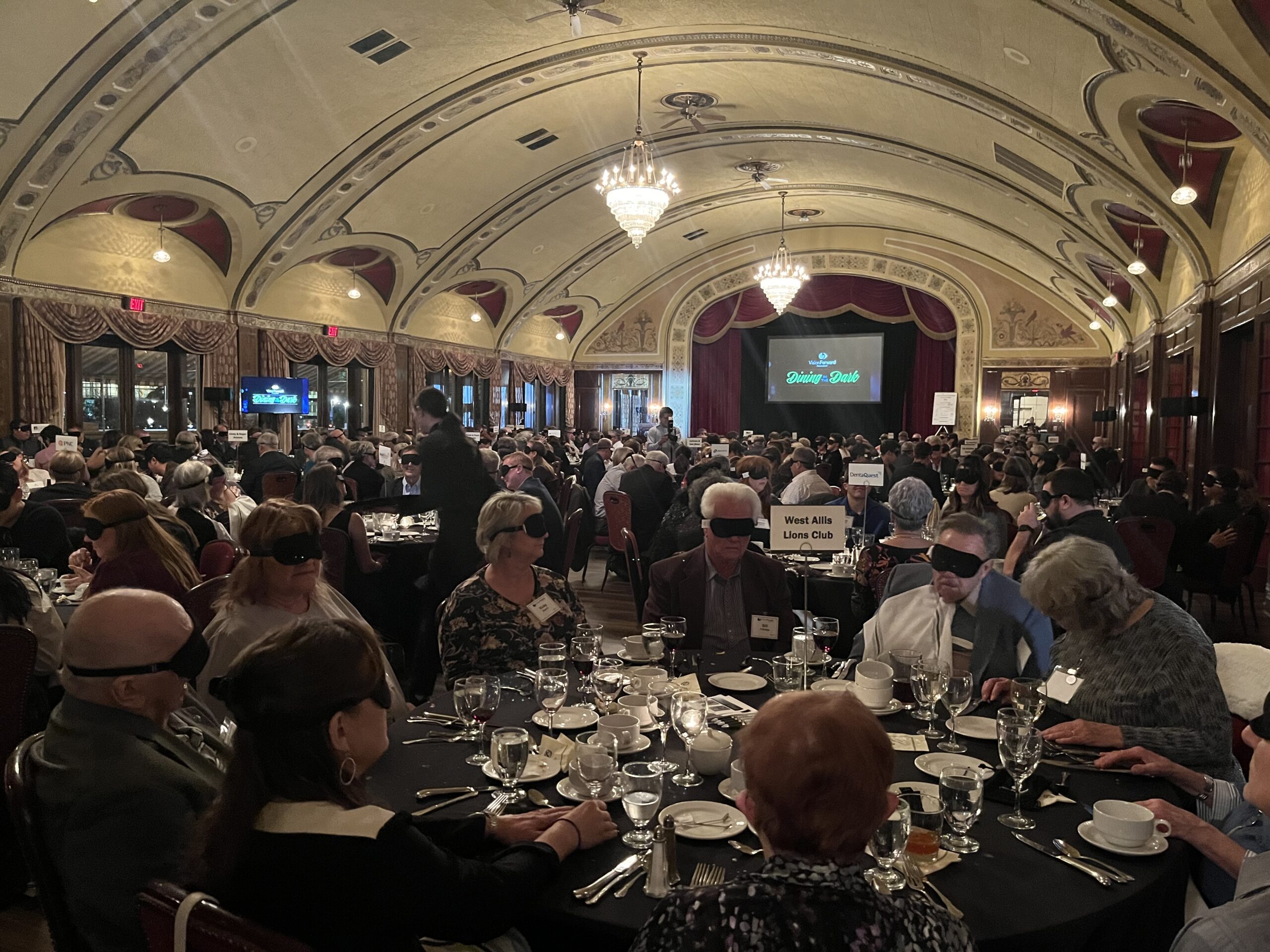 Photo of guests at tables at Dining in the Dark