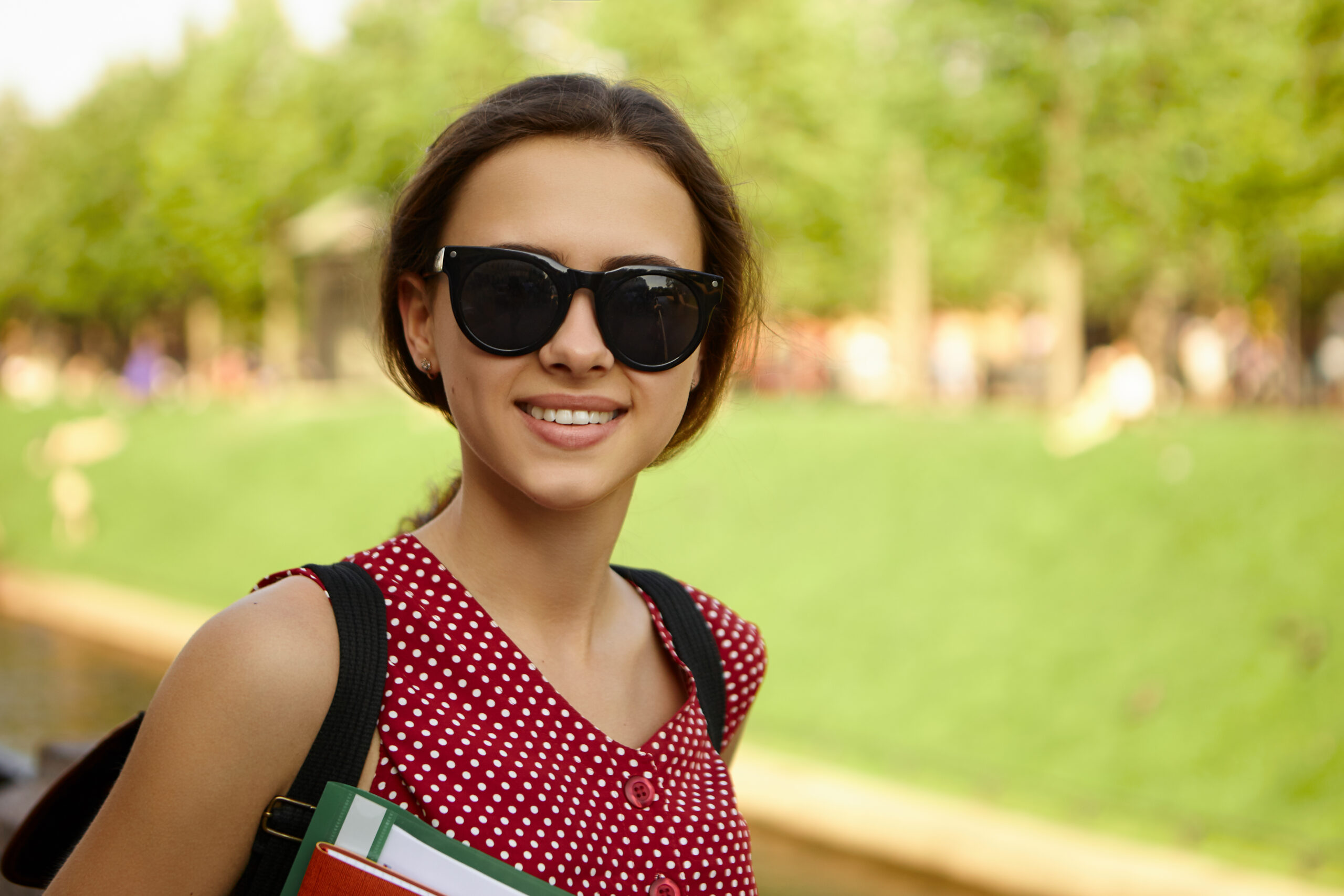 girl student with dark glasses and backpack