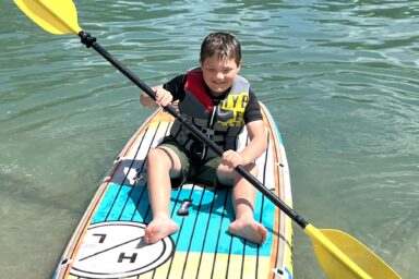Young boy in a kayak on the water