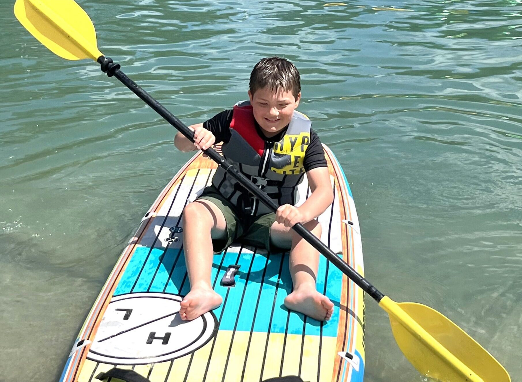 Young boy in a kayak on the water