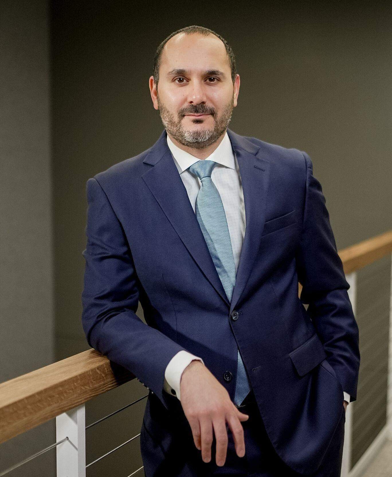 Dr. Coussa in a suit and tie