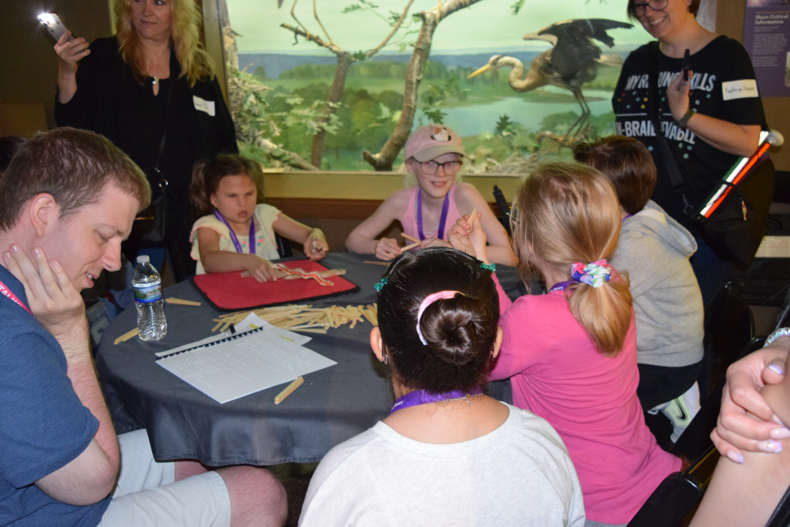 Kids sitting around a table playing a game