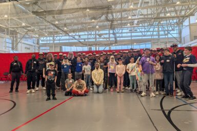 group of baseball players and kids participating in beep baseball
